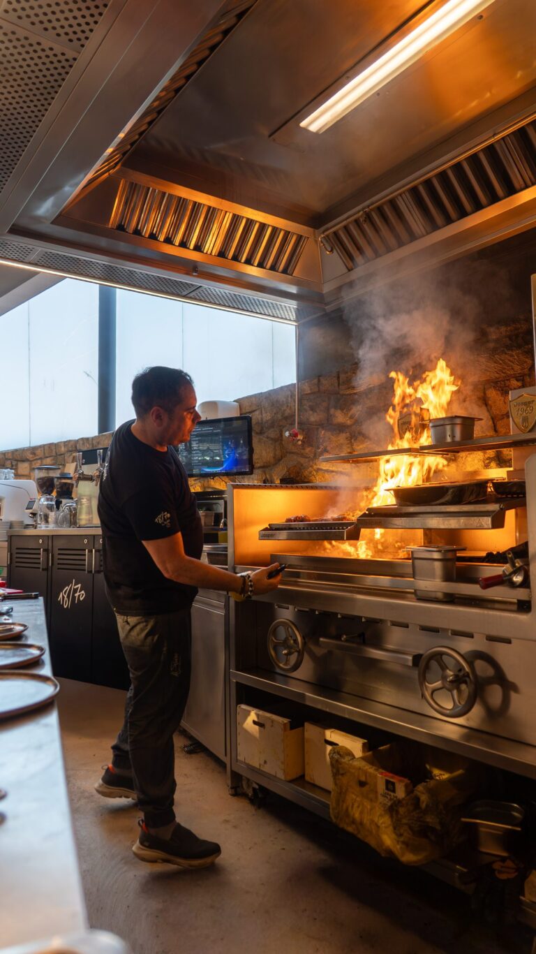A cook at the flaming grill in Al Panino's open kitchen