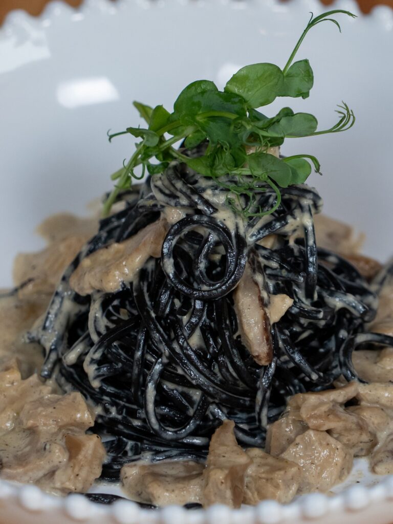 Cuttlefish ink spaghetti with funghi cream