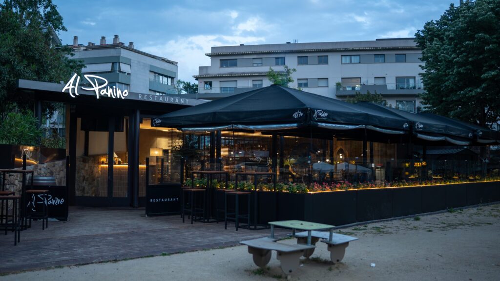 The Al Panino terrace at dusk, with the pergolas