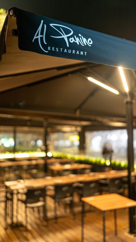 The Al Panino sign on the terrace pergola